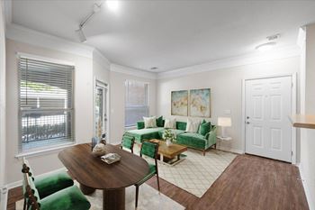 A living room with a green couch and a wooden table.